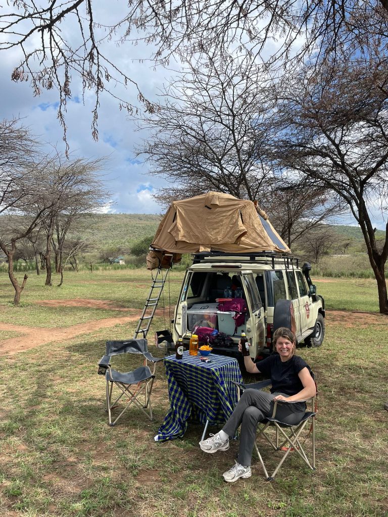 a lady camping with 4x4 in kenya