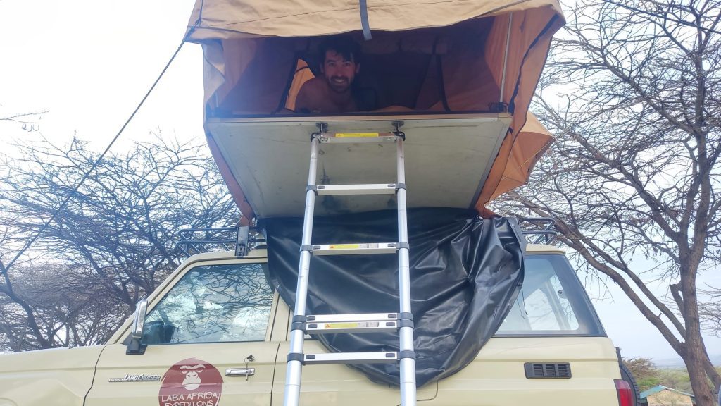 a-tourist-sleeping-in-a-roof-tent-in-kenya